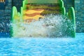 Woman and two boys on a water park slides. Happy family ride on water slides with flowing splash in aqua park Royalty Free Stock Photo