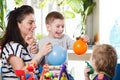 Woman with two children playing with balloons Royalty Free Stock Photo