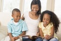 Woman and two children sitting in living room