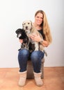 Woman with two dogs on lap Royalty Free Stock Photo