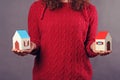 Woman and two houses in hands Royalty Free Stock Photo