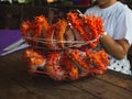 Woman with two king crabs Alaska frozen ready on wood table for cooking Royalty Free Stock Photo