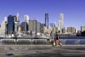 Woman with two labrador dogs walking in Brooklyn Brodge Park with Manhattan view