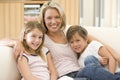 Woman and two young children in living room Royalty Free Stock Photo