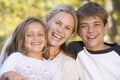 Woman and two young children outdoors laughing Royalty Free Stock Photo