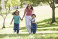 Woman with two young children running smiling