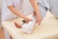 Woman tying bandage on patient's foot Royalty Free Stock Photo