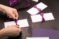 Woman tying a bow on a handmade card