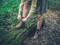 Woman tying her shoes in the forest Royalty Free Stock Photo