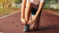 woman tying her shoes on running track. Jogging girl exercise motivation heatlhy fit living