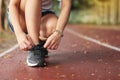 woman tying her shoes on running track. Jogging girl exercise motivation heatlhy fit living