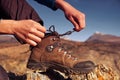 Woman tying hiking boot outdoors on trail in fall Royalty Free Stock Photo