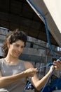 Woman Tying Knot in Rope - Vertical