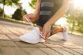 Woman tying laces of sneakers, closeup. Morning fitness Royalty Free Stock Photo