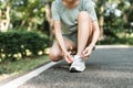 Woman tying shoe laces. Closeup of female sport fitness runner getting ready for jogging outdoors. Royalty Free Stock Photo
