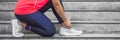 Woman tying shoelace on running shoes before practice. Runner getting ready for training. Sport active lifestyle concept. Outdoor