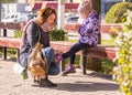 Woman tying shoelaces young daughter.