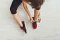 Woman tying up lace on sport shoes top view Royalty Free Stock Photo