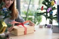 Woman tying xmas gift box with ribbon. Process of package xmas Royalty Free Stock Photo