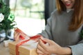 Woman tying xmas gift box with ribbon. Process of package xmas Royalty Free Stock Photo