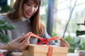 Woman tying xmas gift box with ribbon. Process of package xmas Royalty Free Stock Photo