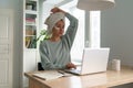 Woman type email on laptop work remotely from home in morning towel on hair and skin care patches