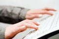 Female hands typing on computer keyboard