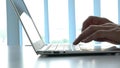 Woman typing on keyboard of computer laptop. Closeup.