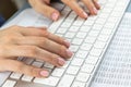 Woman typing on keyboard. Office accounting, counting, translating, copywriting, numbers concept. Close up hands