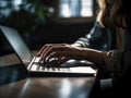 Woman typing on a laptop in the dark