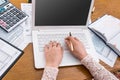 Woman typing on laptop and filling 1040 form Royalty Free Stock Photo