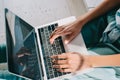 Woman typing on laptop keyboard on her knees Royalty Free Stock Photo