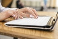 Woman typing on a laptop keyboard in a warm sunny day outdoors, sitting at the cafe table. Space for text Royalty Free Stock Photo