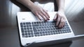 Woman typing on laptop pc