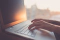 Woman typing on laptop at workplace working in home office hand keyboard.