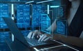 woman typing on a laptop in workspace. The laptop screen displays a holographic interface with blue glowing wireframe documents Royalty Free Stock Photo