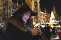 Woman typing on the phone at Christmas market in Munich Royalty Free Stock Photo