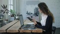 The woman typing and smiling by laptop