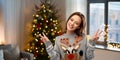 Woman in ugly christmas sweater showing peace sign