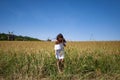 Woman in Ukraine field with spikelet. Summer woman in dress outdoor. Girl and countryside nature. Countryside woman in field. Royalty Free Stock Photo