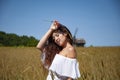 Woman in Ukraine field with spikelet. Summer woman in dress outdoor. Girl and countryside nature. Countryside woman in field.