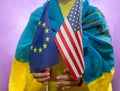 woman in ukraine national flag hold eu and usa flag