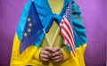 woman in ukraine national flag hold eu and usa flag