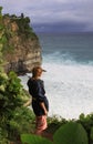 Woman at Uluwatu Bali looking at waves and ocean