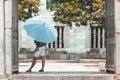 Woman with an umbrella in front of a temple in Vietnam