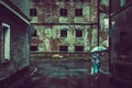 Woman with umbrella on rainy day in town, ruin in the background Royalty Free Stock Photo