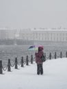 Woman with umbrella under heavy snowfall. Royalty Free Stock Photo