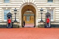 Buckingham palace entrance flanked by two guards Royalty Free Stock Photo