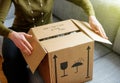 Woman unboxing good cardboard box Royalty Free Stock Photo