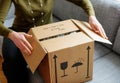 Woman unboxing good cardboard box Royalty Free Stock Photo